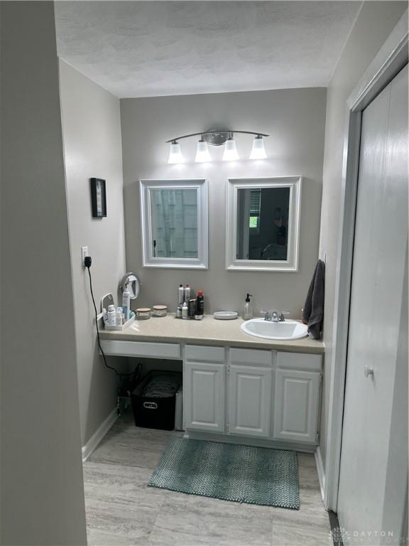 2419 Meadow Green Dr, Beavercreek, OH 45431 - bathroom featuring vanity, wood finished floors, and baseboards