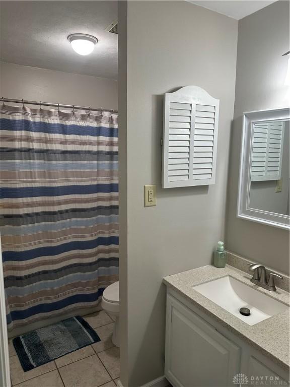 2419 Meadow Green Dr, Beavercreek, OH 45431 - bathroom with vanity, toilet, tile patterned flooring, and curtained shower