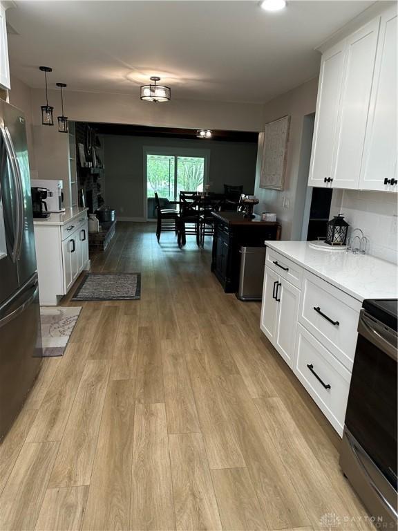 2419 Meadow Green Dr, Beavercreek, OH 45431 - kitchen with appliances with stainless steel finishes, light countertops, light wood finished floors, and white cabinets