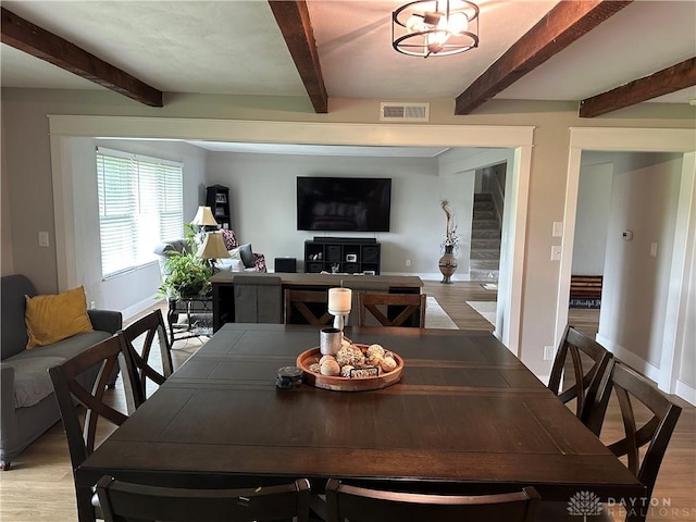 2419 Meadow Green Dr, Beavercreek, OH 45431 - dining room featuring beamed ceiling, light wood finished floors, stairway, and baseboards