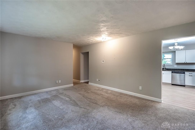 5920 Verdi Dr, West Carrollton, OH 45449 - empty room with light carpet, a chandelier, and baseboards