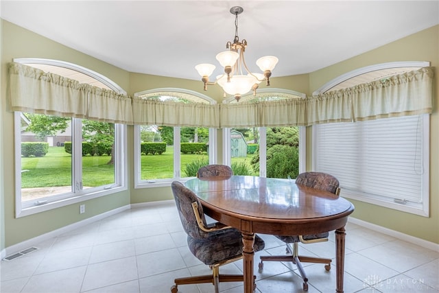 2301 Glenheath Dr, Kettering, OH 45440 - dining area featuring healthy amount of natural light, a chandelier, baseboards, and light tile patterned flooring