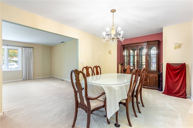 2301 Glenheath Dr, Kettering, OH 45440 - dining space featuring light carpet, a chandelier, and baseboards