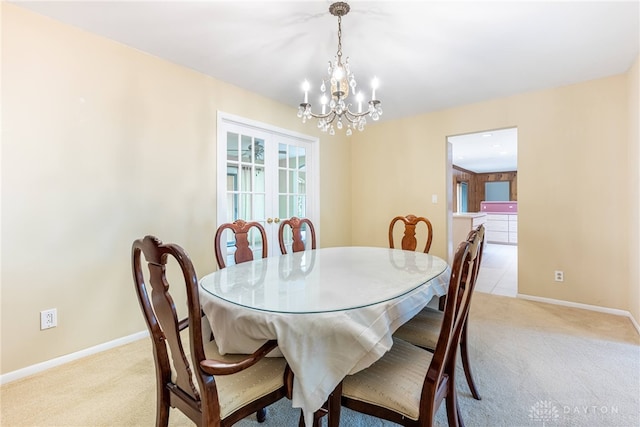2301 Glenheath Dr, Kettering, OH 45440 - dining room featuring light carpet, a chandelier, and baseboards