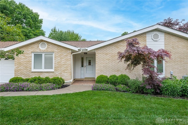 2301 Glenheath Dr, Kettering, OH 45440 - ranch-style house featuring a front lawn, a garage, brick siding, and roof with shingles