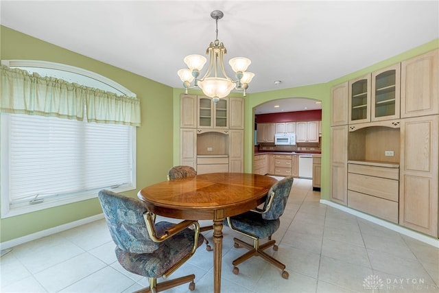 2301 Glenheath Dr, Kettering, OH 45440 - dining area featuring a chandelier, light tile patterned floors, baseboards, and arched walkways