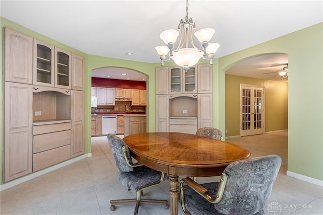 2301 Glenheath Dr, Kettering, OH 45440 - dining room featuring arched walkways, light tile patterned flooring, a chandelier, and baseboards