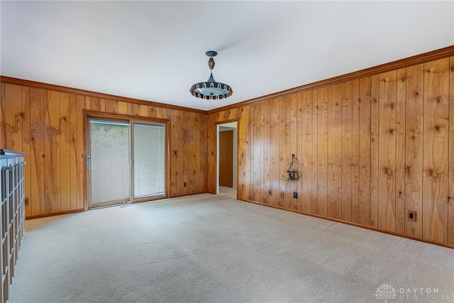 2301 Glenheath Dr, Kettering, OH 45440 - empty room with ornamental molding, wooden walls, carpet flooring, and baseboards