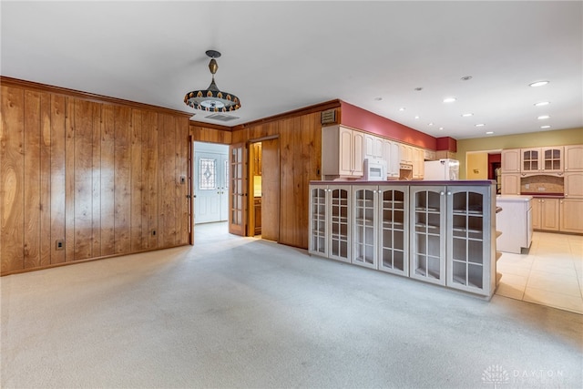 2301 Glenheath Dr, Kettering, OH 45440 - unfurnished living room with wooden walls, ornamental molding, and light colored carpet