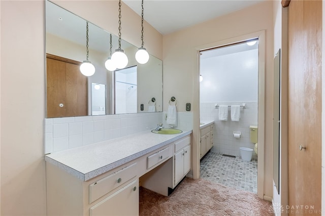 2301 Glenheath Dr, Kettering, OH 45440 - full bathroom with vanity, toilet, tile walls, and decorative backsplash