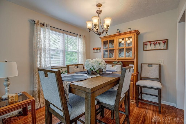 286 Chamberlin Dr, Hamilton, OH 45013 - dining room featuring a chandelier, wood finished floors, and baseboards