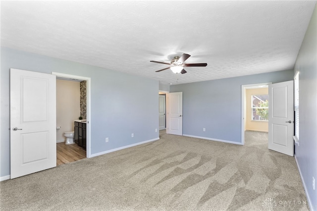 109 Waterford Blvd, Fairborn, OH 45324 - unfurnished bedroom with carpet flooring, connected bathroom, a textured ceiling, and a ceiling fan