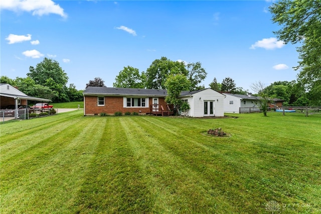 479 E Lomar Ave, Franklin, OH 45005 - back of house with an outdoor fire pit, brick siding, and french doors