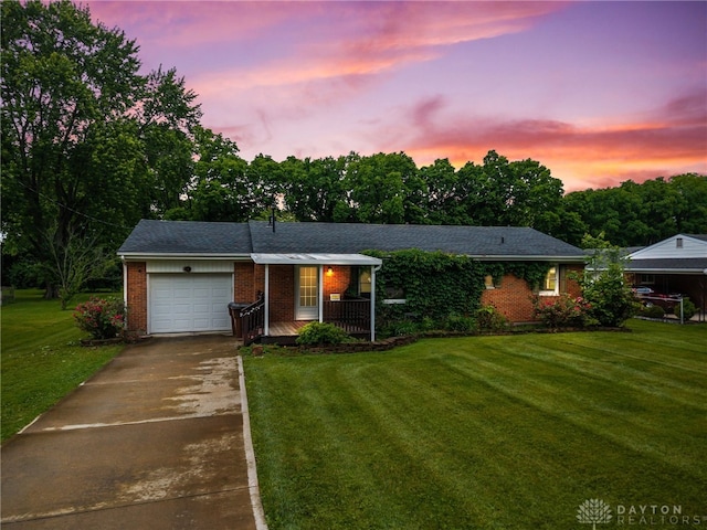 479 E Lomar Ave, Franklin, OH 45005 - ranch-style house featuring brick siding, a garage, a front lawn, driveway, and a porch