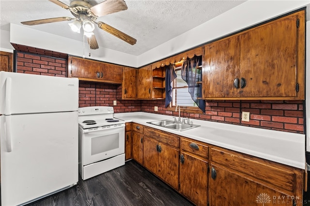 479 E Lomar Ave, Franklin, OH 45005 - kitchen featuring white appliances, a sink, a textured ceiling, dark wood finished floors, and light countertops