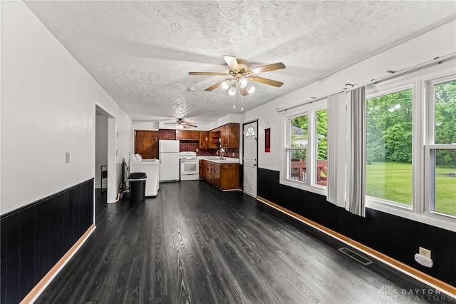 479 E Lomar Ave, Franklin, OH 45005 - unfurnished living room with washer / clothes dryer, a textured ceiling, a sink, a ceiling fan, and dark wood-style floors