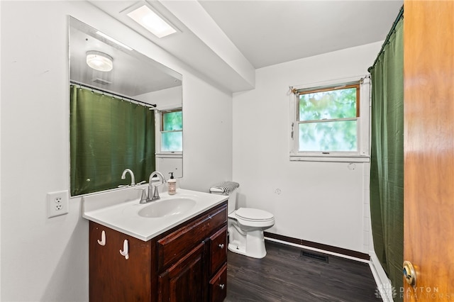 479 E Lomar Ave, Franklin, OH 45005 - bathroom with vanity, wood finished floors, toilet, and healthy amount of natural light