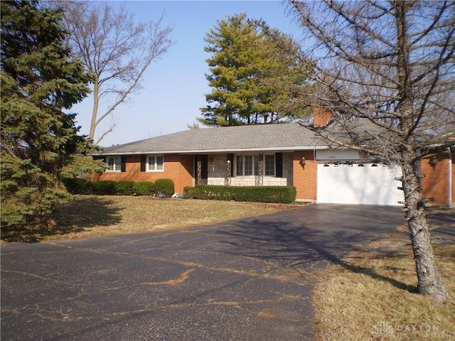 1086 Grange Hall Rd, Beavercreek, OH 45430 - ranch-style home featuring asphalt driveway, a garage, brick siding, and a front yard