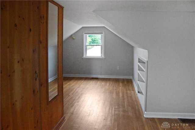 3145 Mohican Ave, Kettering, OH 45429 - additional living space with wood finished floors, lofted ceiling, built in features, and baseboards