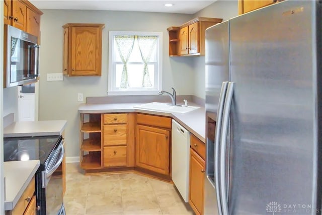 3145 Mohican Ave, Kettering, OH 45429 - kitchen featuring appliances with stainless steel finishes, open shelves, a sink, brown cabinets, and light countertops