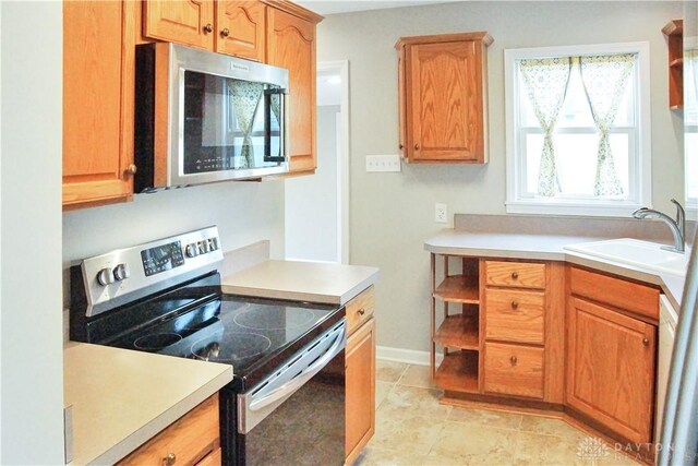 3145 Mohican Ave, Kettering, OH 45429 - kitchen featuring stainless steel appliances, a sink, light countertops, and open shelves