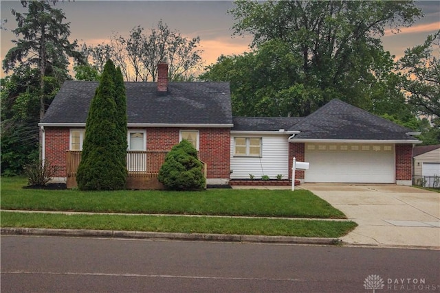 3145 Mohican Ave, Kettering, OH 45429 - view of front facade with brick siding, an attached garage, driveway, a chimney, and a front yard