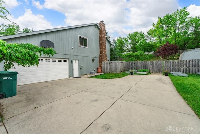 360 Merrick Dr, Beavercreek, OH 45434 - view of property exterior with a chimney and a garage