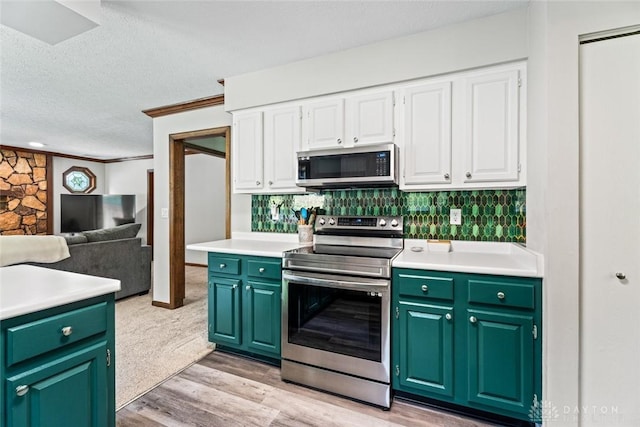 360 Merrick Dr, Beavercreek, OH 45434 - kitchen featuring appliances with stainless steel finishes, white cabinetry, green cabinetry, a textured ceiling, and crown molding