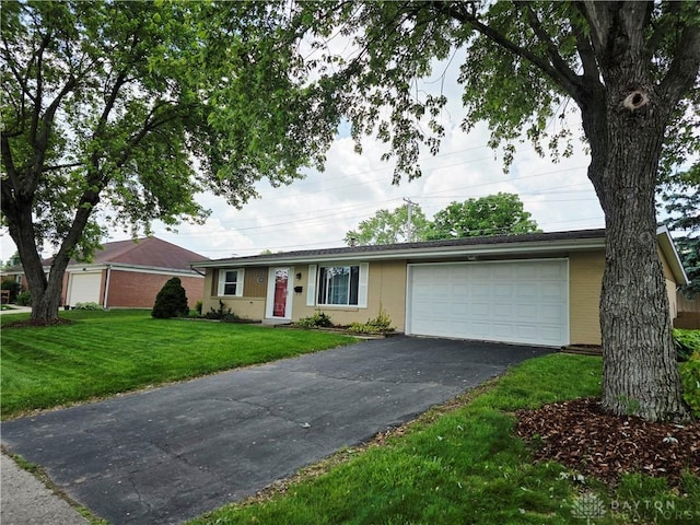 1008 Terracewood Dr, Englewood, OH 45322 - ranch-style home with asphalt driveway, a garage, and a front lawn