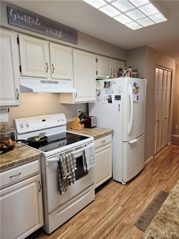 1008 Terracewood Dr, Englewood, OH 45322 - kitchen with white appliances, under cabinet range hood, white cabinets, light wood-style floors, and light countertops