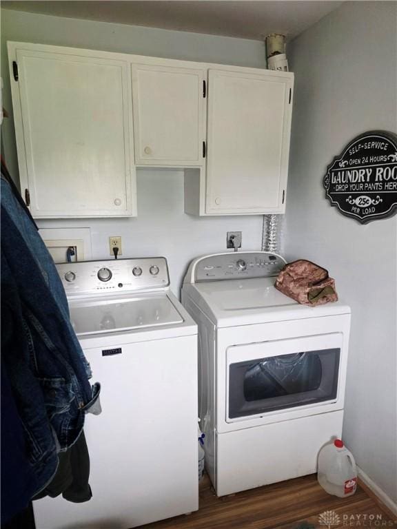 1008 Terracewood Dr, Englewood, OH 45322 - washroom featuring washing machine and dryer, cabinet space, and wood finished floors