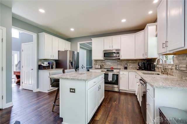4037 Andora Blvd, Amelia, OH 45102 - kitchen with appliances with stainless steel finishes, a sink, dark wood-style floors, tasteful backsplash, and recessed lighting