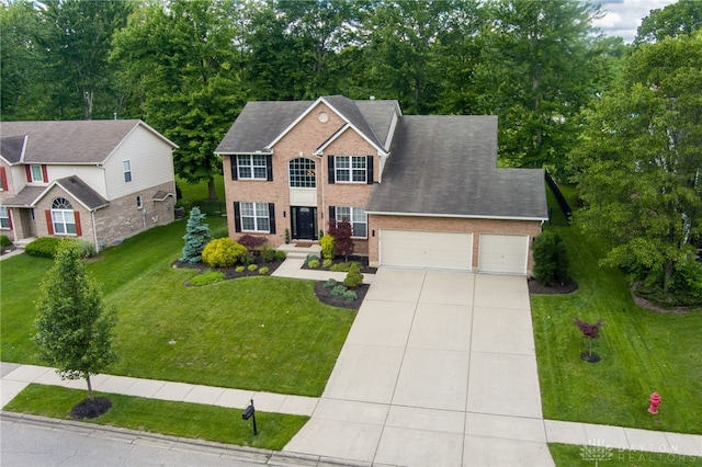 4037 Andora Blvd, Amelia, OH 45102 - view of front of property with an attached garage, driveway, a front lawn, and brick siding