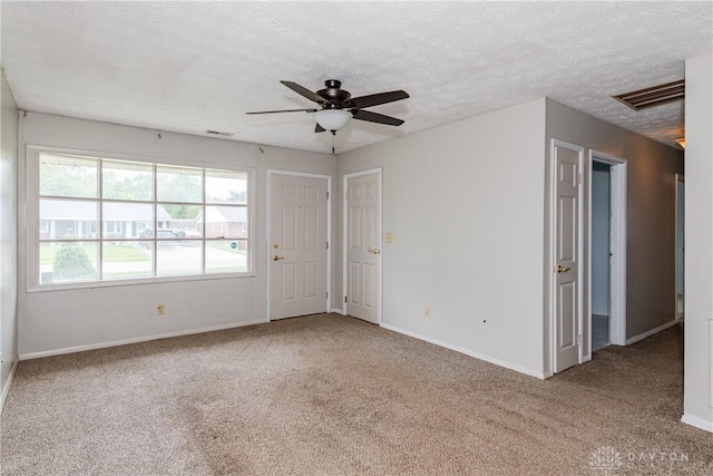 520 Buttercup Ave, Vandalia, OH 45377 - spare room featuring carpet, healthy amount of natural light, a ceiling fan, and a textured ceiling