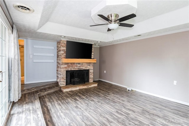 520 Buttercup Ave, Vandalia, OH 45377 - unfurnished living room featuring a raised ceiling, wood finished floors, a fireplace, a textured ceiling, and crown molding
