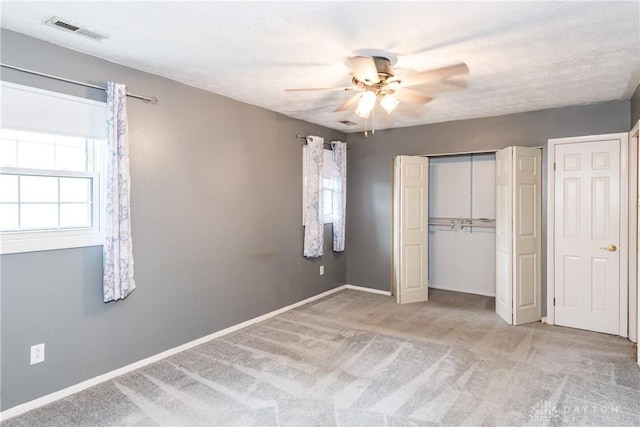 520 Buttercup Ave, Vandalia, OH 45377 - unfurnished bedroom with multiple windows, carpet, a closet, and a ceiling fan