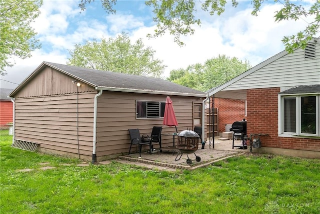 520 Buttercup Ave, Vandalia, OH 45377 - back of property with a yard, a patio, and brick siding