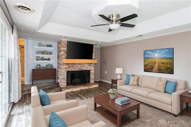 520 Buttercup Ave, Vandalia, OH 45377 - living room with a tray ceiling, wood finished floors, a stone fireplace, and crown molding