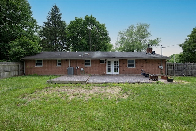 1172 Bay Ln, Beavercreek, OH 45430 - back of property with french doors, a wooden deck, central AC, a fire pit, and brick siding