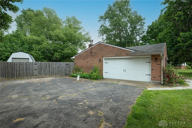 1172 Bay Ln, Beavercreek, OH 45430 - view of side of home with brick siding, a chimney, and a garage