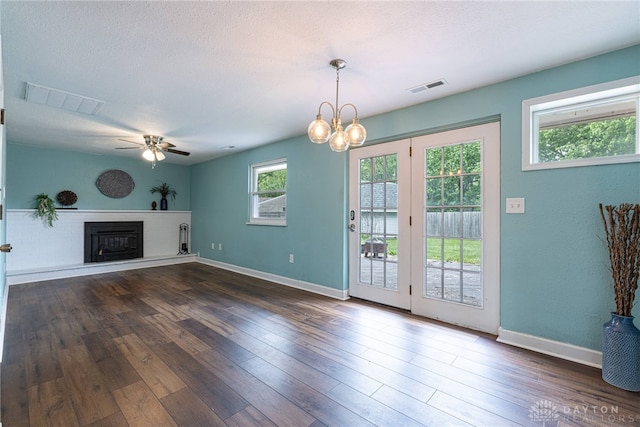 1172 Bay Ln, Beavercreek, OH 45430 - unfurnished living room with healthy amount of natural light, a fireplace with raised hearth, ceiling fan, baseboards, and a textured ceiling