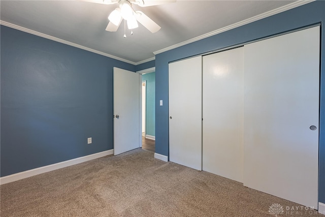 1172 Bay Ln, Beavercreek, OH 45430 - unfurnished bedroom featuring carpet, crown molding, a closet, baseboards, and a ceiling fan