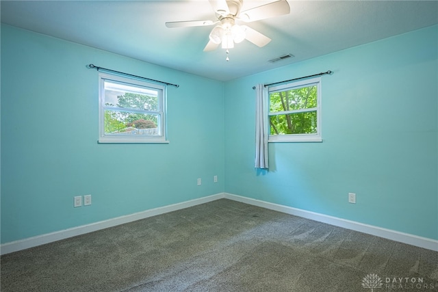 1172 Bay Ln, Beavercreek, OH 45430 - unfurnished room featuring plenty of natural light, dark colored carpet, baseboards, and a ceiling fan