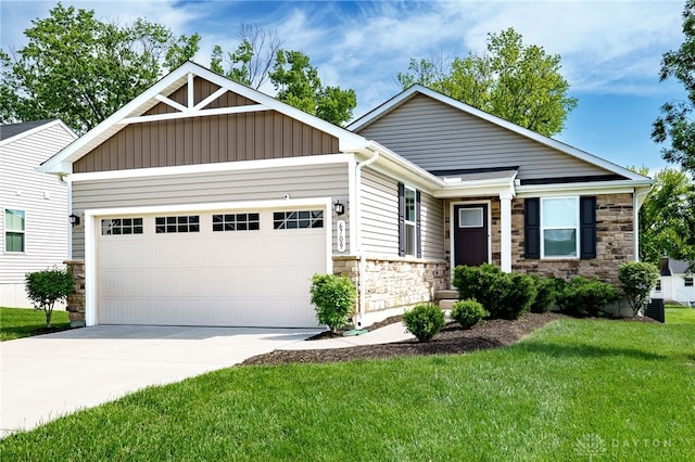 6709 Crystal Harbour Dr, Middletown, OH 45042 - view of front of home featuring stone siding, an attached garage, driveway, a front yard, and board and batten siding