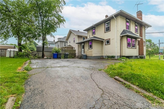 2600 Wayne Ave, Dayton, OH 45420 - view of property exterior featuring a chimney and asphalt driveway