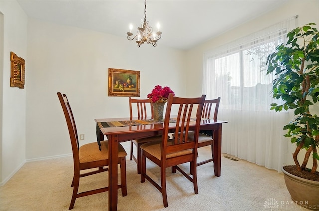 348 Cambridge Dr, Fairborn, OH 45324 - dining room with light carpet, a chandelier, and baseboards
