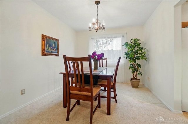 348 Cambridge Dr, Fairborn, OH 45324 - dining area with light carpet, a chandelier, and baseboards
