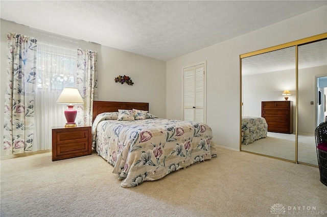 348 Cambridge Dr, Fairborn, OH 45324 - bedroom with carpet floors, two closets, and a textured ceiling