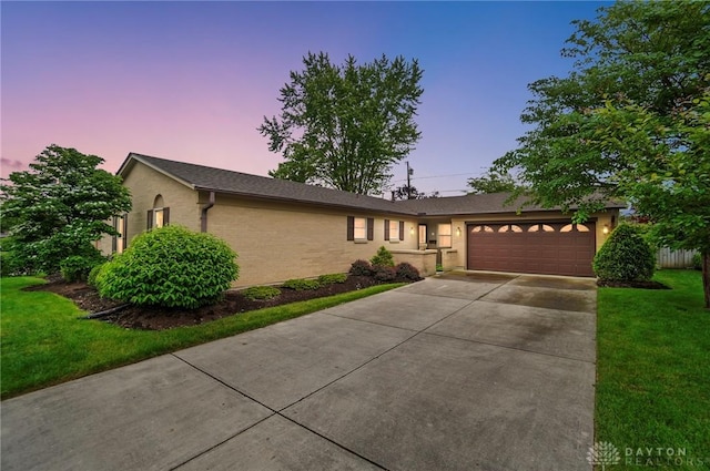 348 Cambridge Dr, Fairborn, OH 45324 - ranch-style home with a garage, concrete driveway, and a lawn