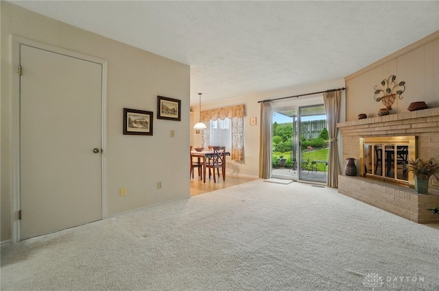 348 Cambridge Dr, Fairborn, OH 45324 - living area featuring a brick fireplace, carpet flooring, and baseboards